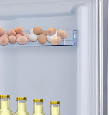 Close-up of the adjustable door balconies holding bottles and eggs